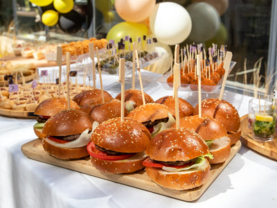 Burger and different food on a buffet table