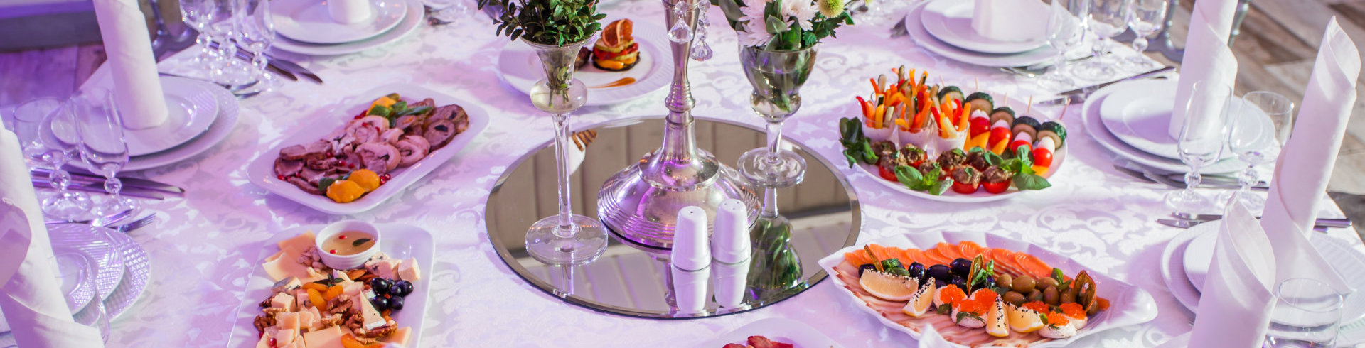 a silver canister with flowers and salt shakers on a table