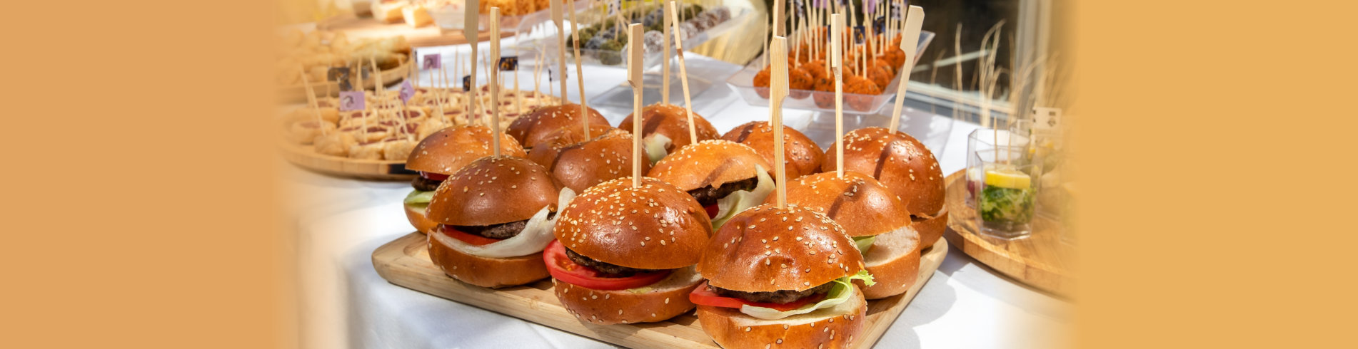 Burger and different food on a buffet table
